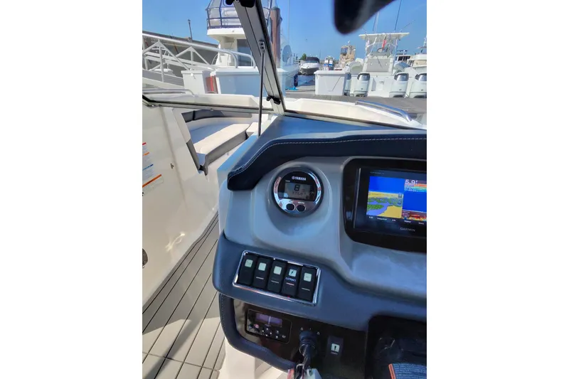 Slide: The Image of 2018 Chaparral 230 Suncoast boat dashboard with navigation system and controls. - 12