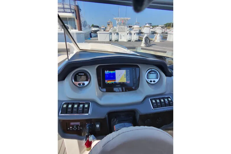 Slide: The Image of Dashboard of a 2018 Chaparral 230 Suncoast boat with navigation display. - 14
