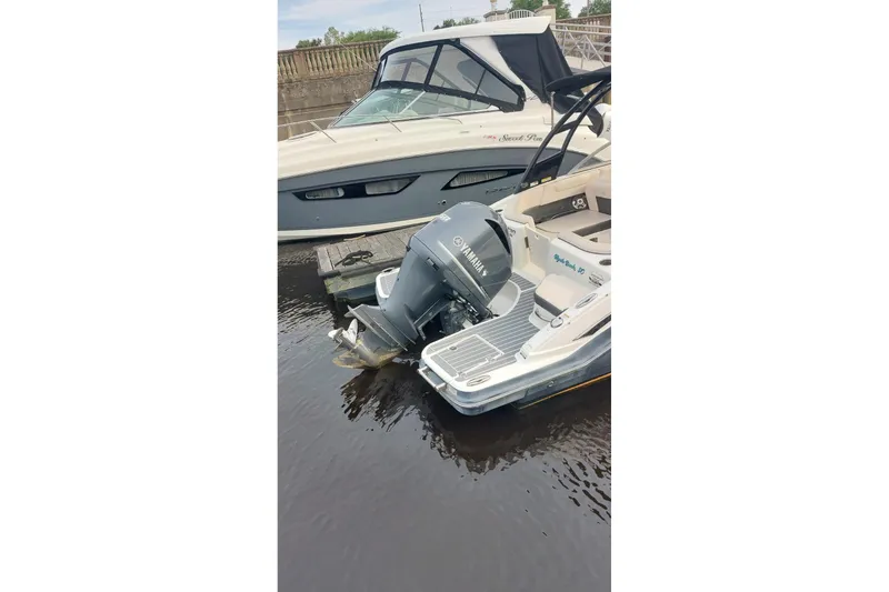 Slide: The Image of 2018 Chaparral 230 Suncoast boat docked with Yamaha outboard motor. - 3