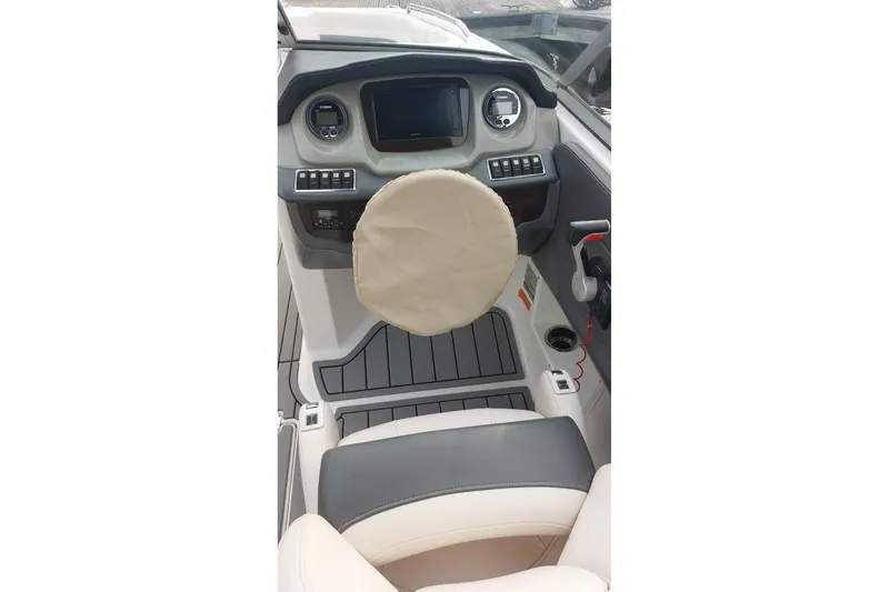 Slide: The Image of 2018 Chaparral 230 Suncoast boat cockpit with steering wheel and control panel. - 6