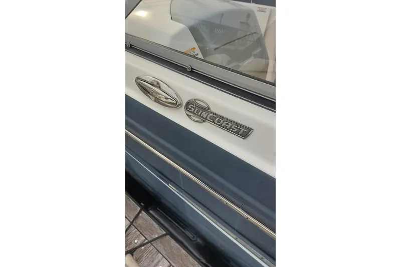 Slide: The Image of 2018 Chaparral 230 Suncoast boat emblem on side panel, close-up view. - 9