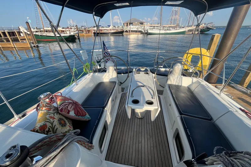 Slide: The Image of Cockpit of 2005 Jeanneau Sun Odyssey 40.3 sailboat docked at marina, featuring cushioned seating. - 13