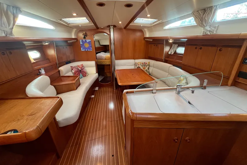 Slide: The Image of Interior of 2005 Jeanneau Sun Odyssey 40.3 yacht with elegant wood finish and cozy seating. - 25
