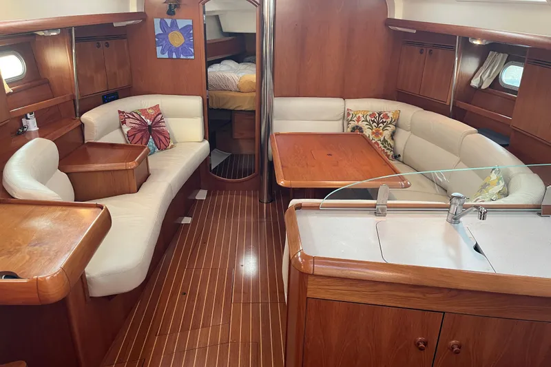 Slide: The Image of Interior of 2005 Jeanneau Sun Odyssey 40.3 yacht with wood finish and cozy seating. - 26