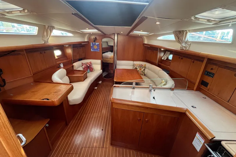 Slide: The Image of Interior of 2005 Jeanneau Sun Odyssey 40.3 sailboat with wood finish and cozy seating area. - 29