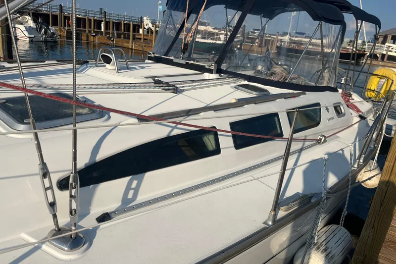 Slide: The Image of 2005 Jeanneau Sun Odyssey 40.3 sailboat docked at a marina, showcasing sleek design and rigging. - 3