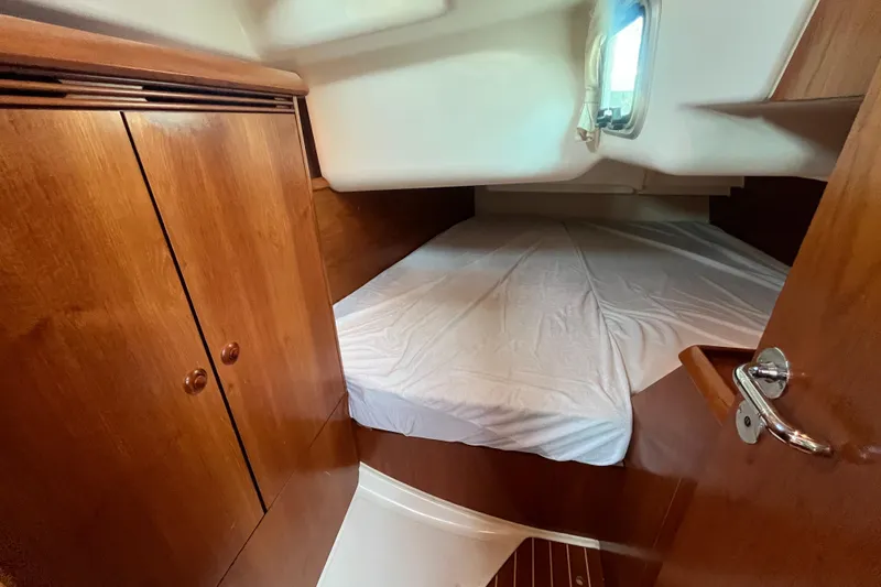 Slide: The Image of Cozy cabin interior of 2005 Jeanneau Sun Odyssey 40.3 sailboat with wooden finishes. - 32