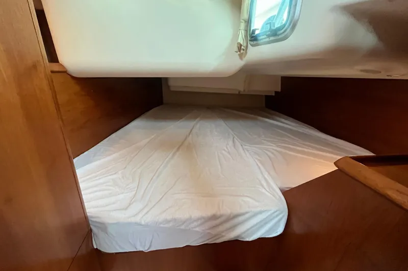 Slide: The Image of Interior cabin of 2005 Jeanneau Sun Odyssey 40.3 sailboat with cozy bed and wooden finish. - 33
