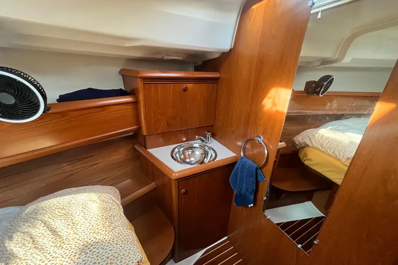 Slide: The Image of Cozy cabin interior of 2005 Jeanneau Sun Odyssey 40.3 with wooden finish and compact sink. - 38