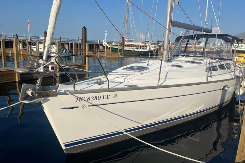 Slide: The Image of 2005 Jeanneau Sun Odyssey 40.3 sailboat docked at marina, reflecting on calm water. - 4