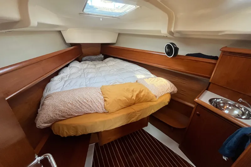 Slide: The Image of Cozy cabin interior of 2005 Jeanneau Sun Odyssey 40.3 sailboat with bed and sink. - 40