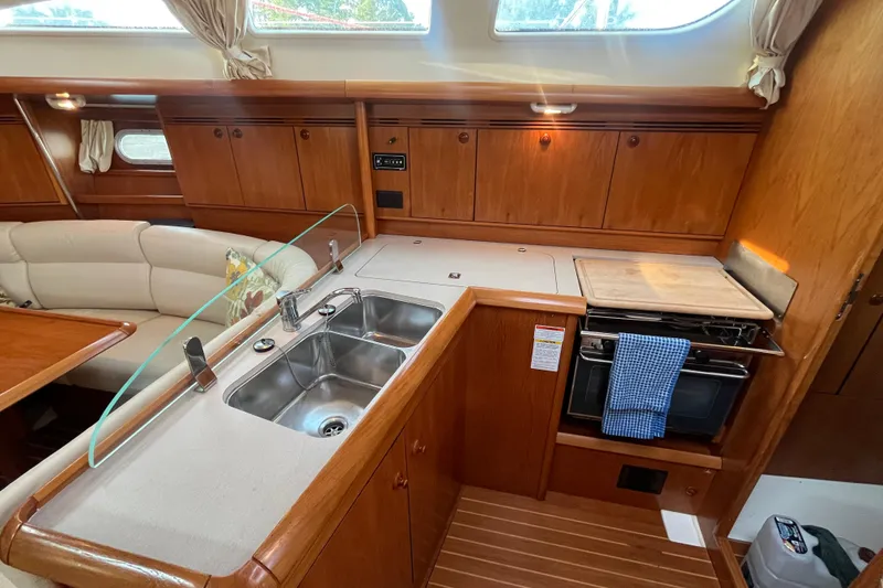 Slide: The Image of Interior of 2005 Jeanneau Sun Odyssey 40.3 yacht, featuring kitchen and seating area. - 45