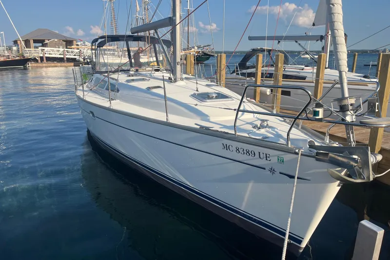 Slide: The Image of 2005 Jeanneau Sun Odyssey 40.3 sailboat docked at marina under clear blue sky. - 5