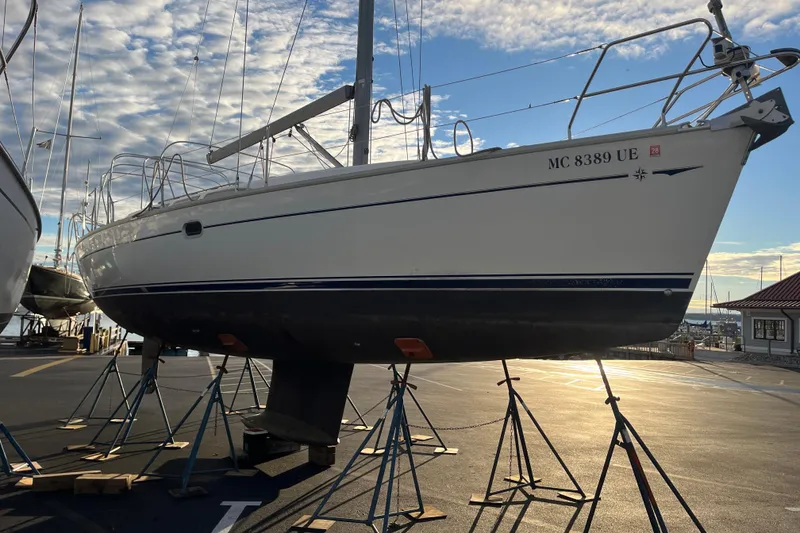 Slide: The Image of 2005 Jeanneau Sun Odyssey 40.3 sailboat on stands in a marina at sunset. - 57