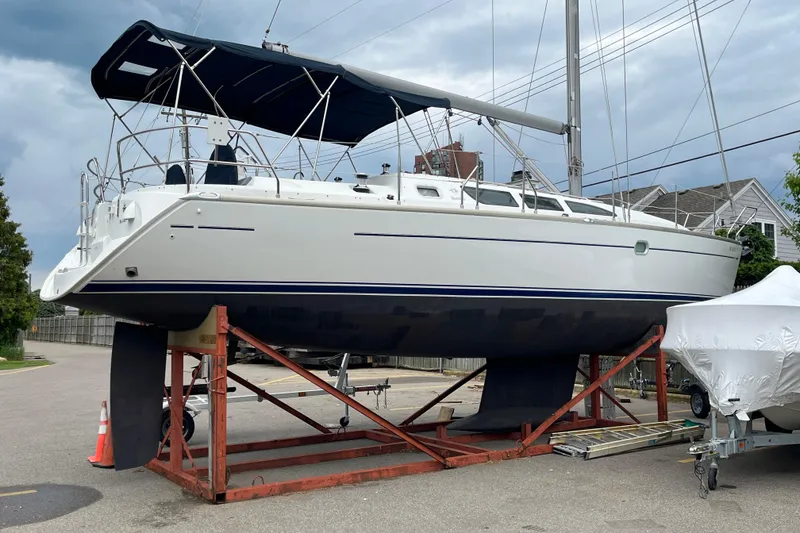 Slide: The Image of 2005 Jeanneau Sun Odyssey 40.3 sailboat on dry dock, with blue and white hull. - 58