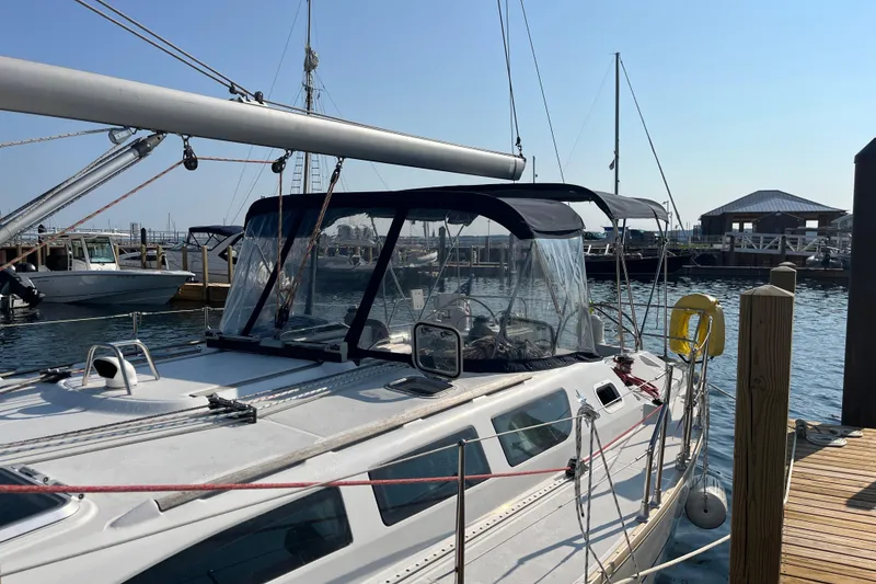 Slide: The Image of 2005 Jeanneau Sun Odyssey 40.3 sailboat docked at marina under clear blue sky. - 6