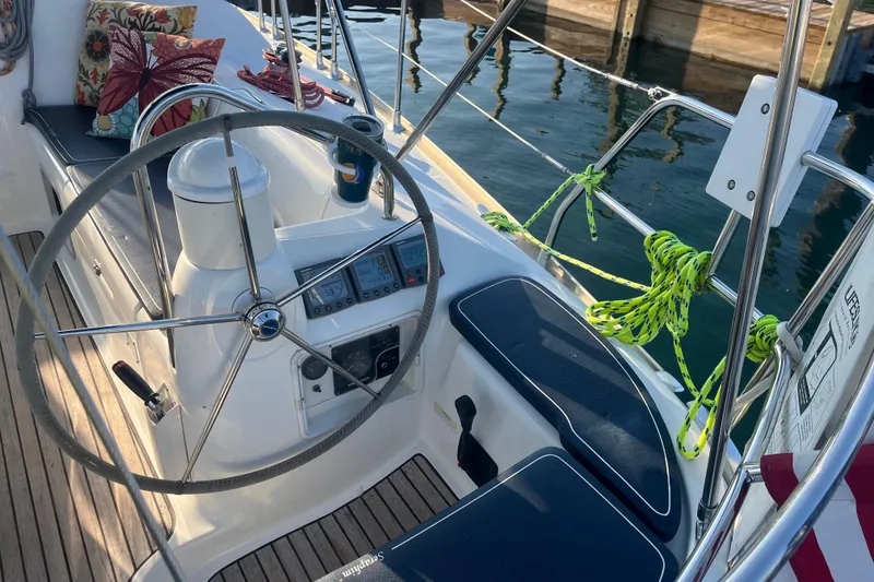 Slide: The Image of Cockpit of 2005 Jeanneau Sun Odyssey 40.3 sailboat with steering wheel and navigation instruments. - 8