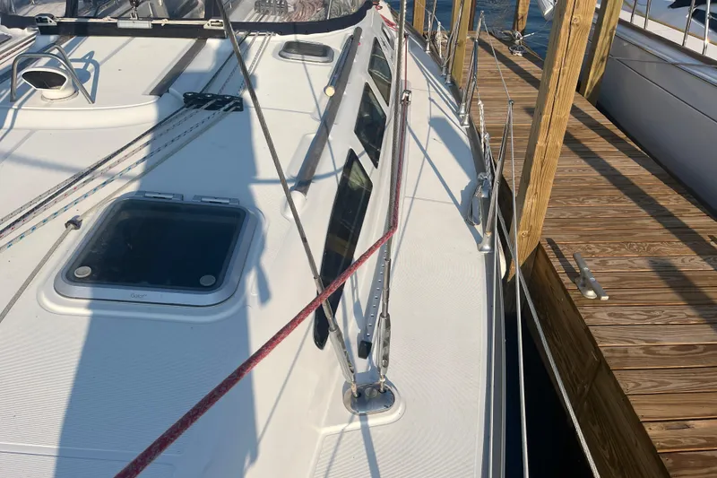 Slide: The Image of 2005 Jeanneau Sun Odyssey 40.3 sailboat docked, showcasing deck and rigging details. - 9