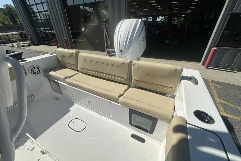Slide: The Image of 2026 Sportsman Heritage 231 Center Console boat with beige seating and outboard motor. - 10