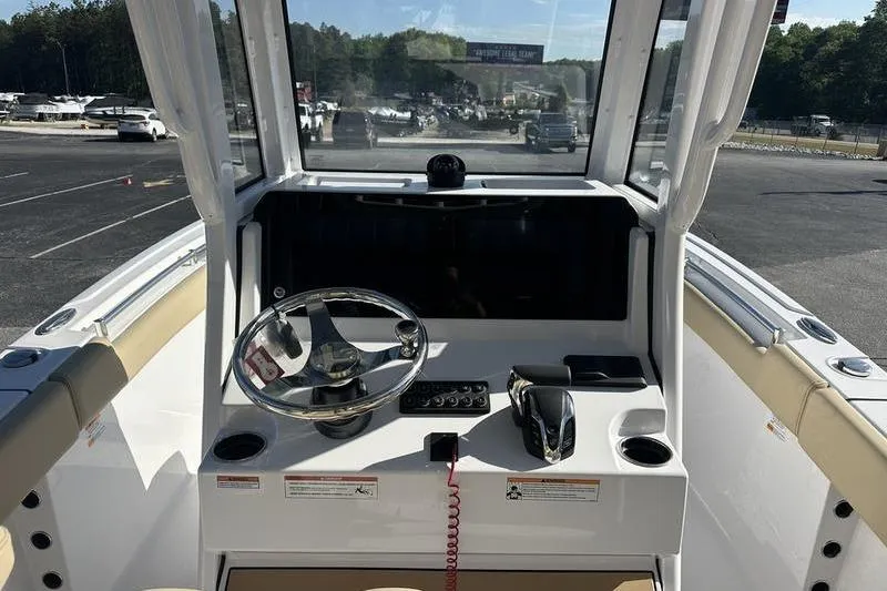 Slide: The Image of Center console of 2026 Sportsman Heritage 231 boat, featuring steering wheel and controls. - 12