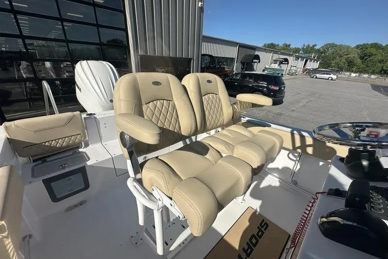 Slide: The Image of 2026 Sportsman Heritage 231 Center Console boat with luxurious beige seating. - 13