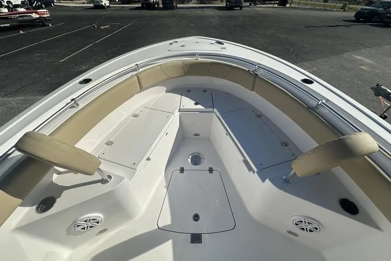 Slide: The Image of 2026 Sportsman Heritage 231 Center Console boat interior with cushioned seating and storage compartments. - 16