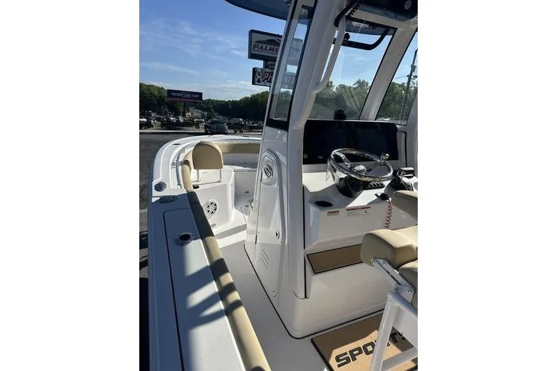 Slide: The Image of 2026 Sportsman Heritage 231 Center Console boat interior with steering wheel and seating. - 17