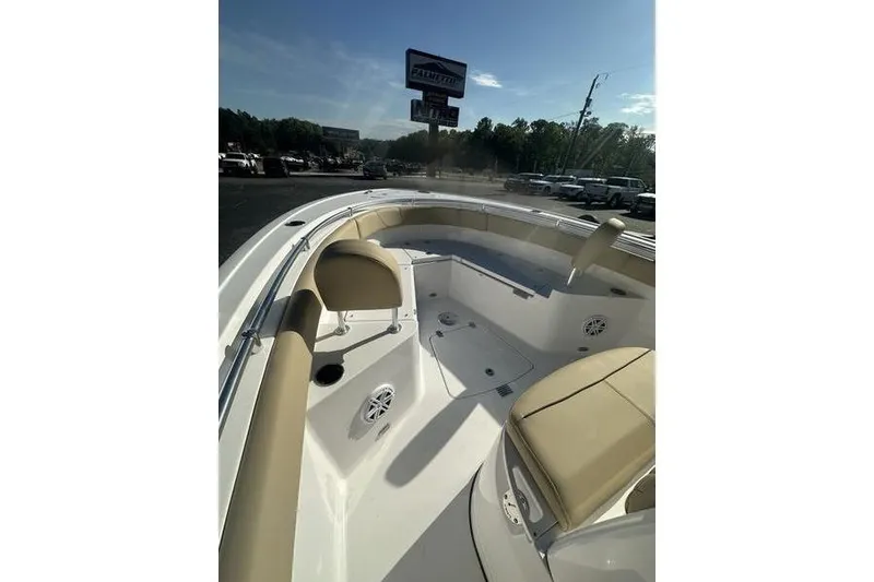 Slide: The Image of 2026 Sportsman Heritage 231 Center Console boat interior with beige seating and speakers. - 19