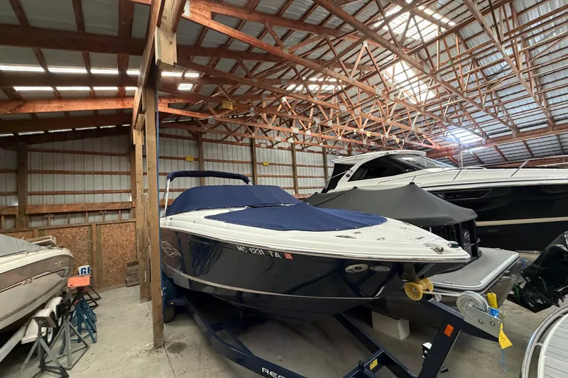 Slide: The Image of 2008 Regal 2700 Bowrider boat stored in a wooden indoor facility. - 10