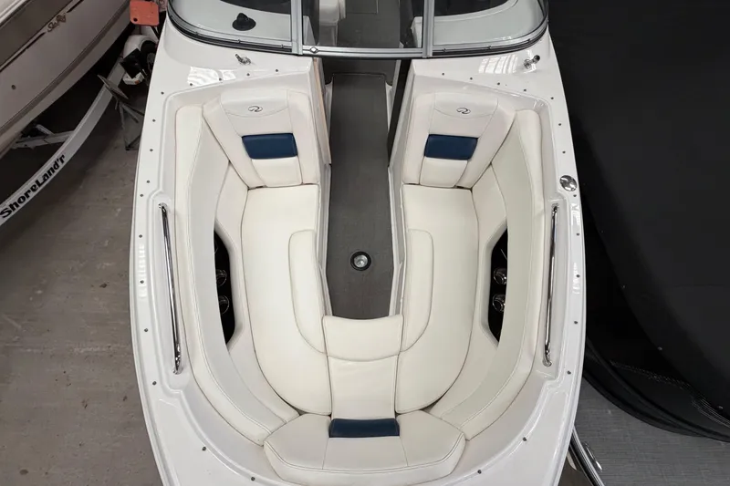 Slide: The Image of 2008 Regal 2700 Bowrider boat interior with white seating and blue accents. - 13