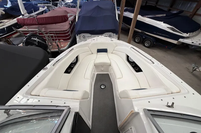 Slide: The Image of 2008 Regal 2700 Bowrider boat with white seating in storage facility. - 14