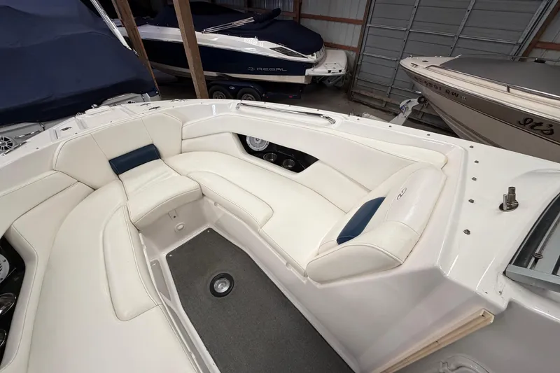 Slide: The Image of 2008 Regal 2700 Bowrider boat interior with white seating in storage. - 15