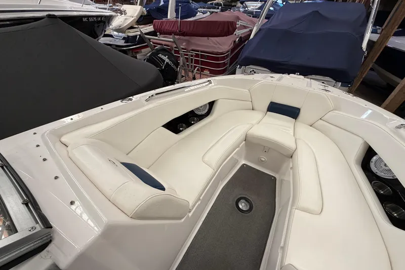 Slide: The Image of 2008 Regal 2700 Bowrider boat interior with white seating in showroom. - 16