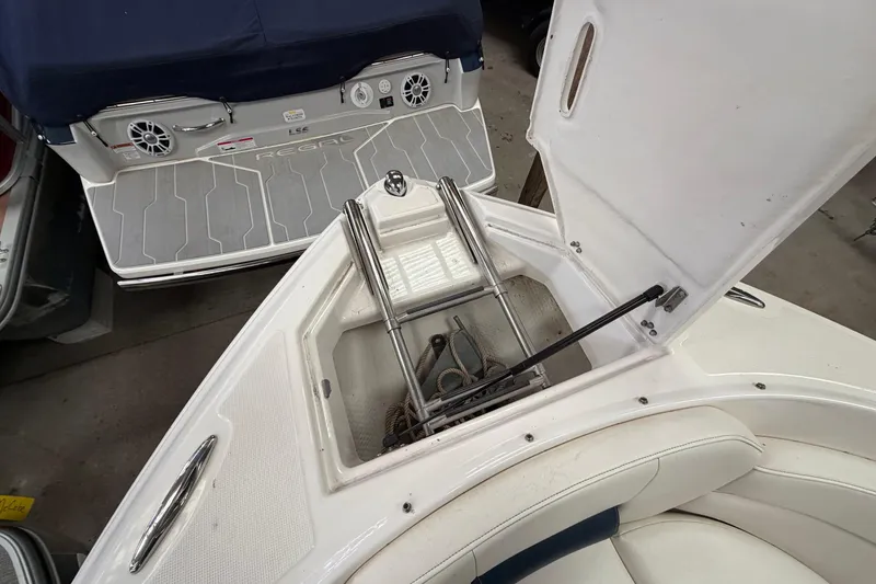 Slide: The Image of 2008 Regal 2700 Bowrider boat with open storage compartment and visible anchor. - 17
