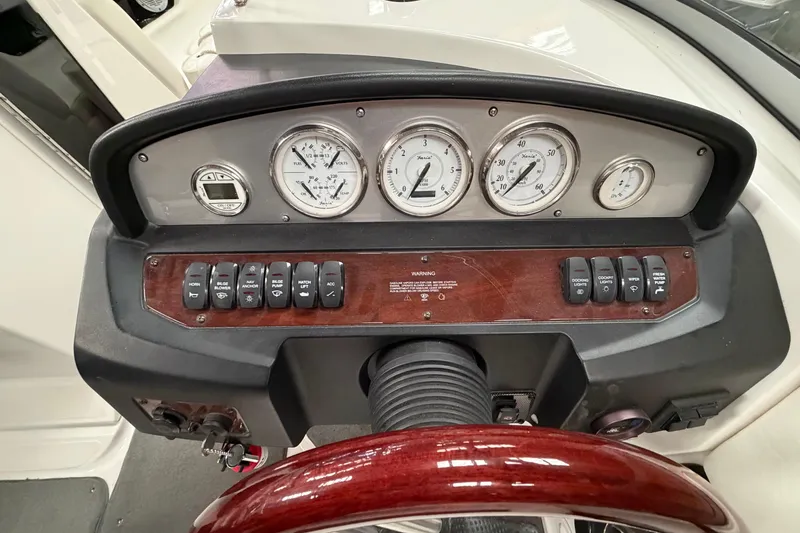 Slide: The Image of Dashboard of a 2008 Regal 2700 Bowrider boat with gauges and controls. - 21