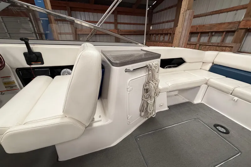 Slide: The Image of 2008 Regal 2700 Bowrider interior with white seating and storage compartment. - 28