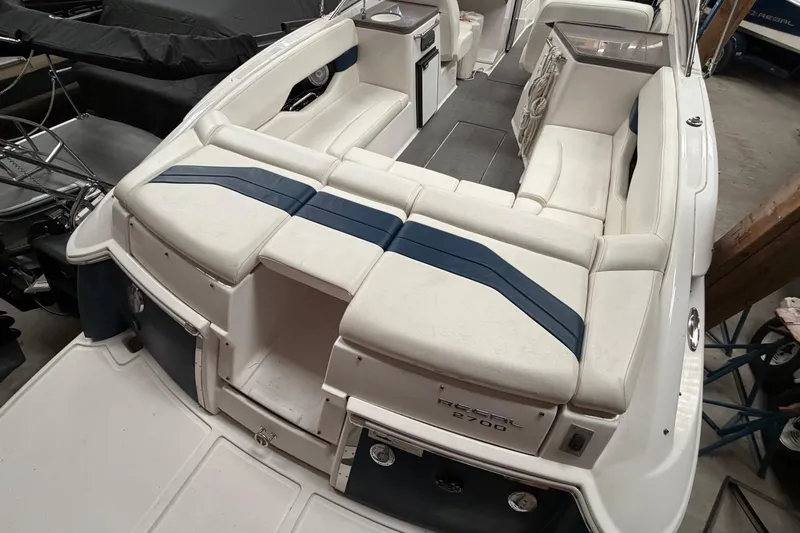 Slide: The Image of 2008 Regal 2700 Bowrider boat interior with white seating and blue accents. - 34