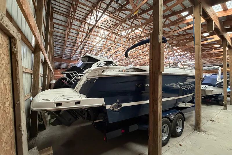 Slide: The Image of 2008 Regal 2700 Bowrider boat stored in a wooden indoor facility. - 5