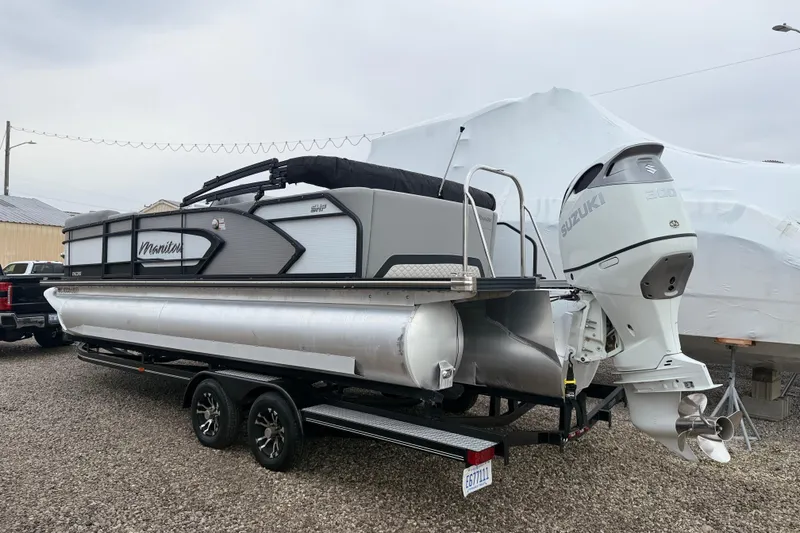 Slide: The Image of 2022 Manitou 230 Encore SL SHP pontoon boat with Suzuki engine on trailer. - 13