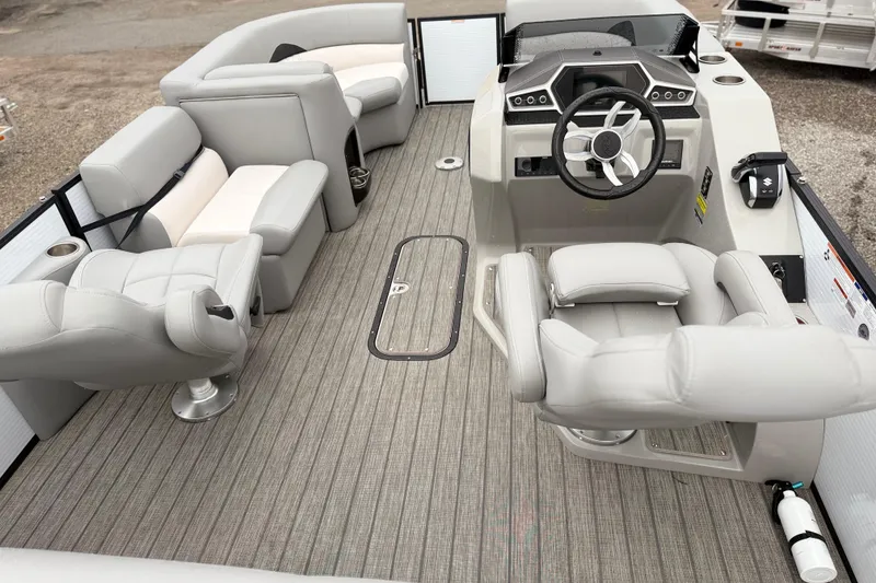 Slide: The Image of 2022 Manitou 230 Encore SL SHP pontoon boat interior with gray seating and steering console. - 3