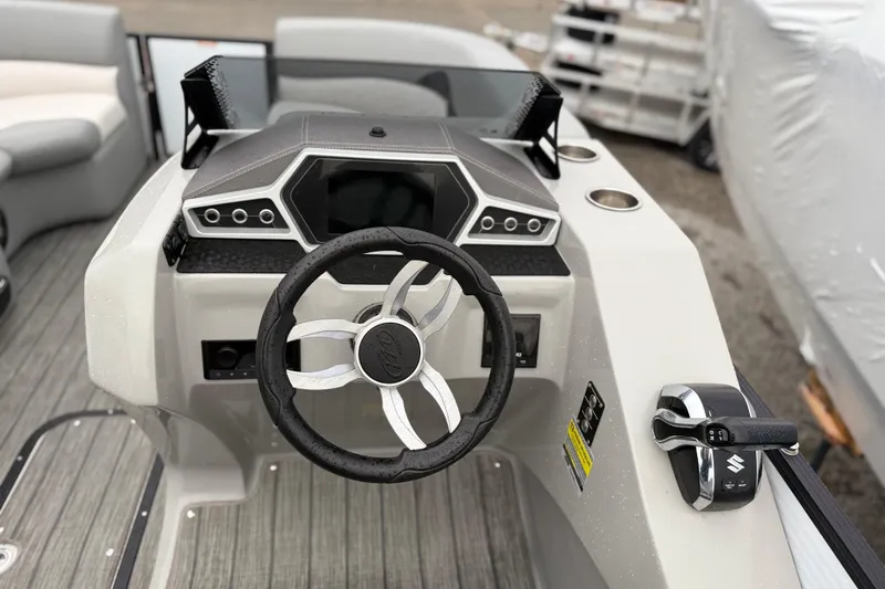Slide: The Image of Steering console of 2022 Manitou 230 Encore SL SHP pontoon boat, featuring modern controls. - 4