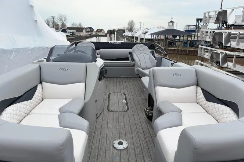 Slide: The Image of 2022 Manitou 230 Encore SL SHP pontoon boat with luxurious seating and modern design. - 5