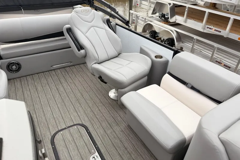 Slide: The Image of Luxurious interior of 2022 Manitou 230 Encore SL SHP pontoon boat with plush seating. - 7