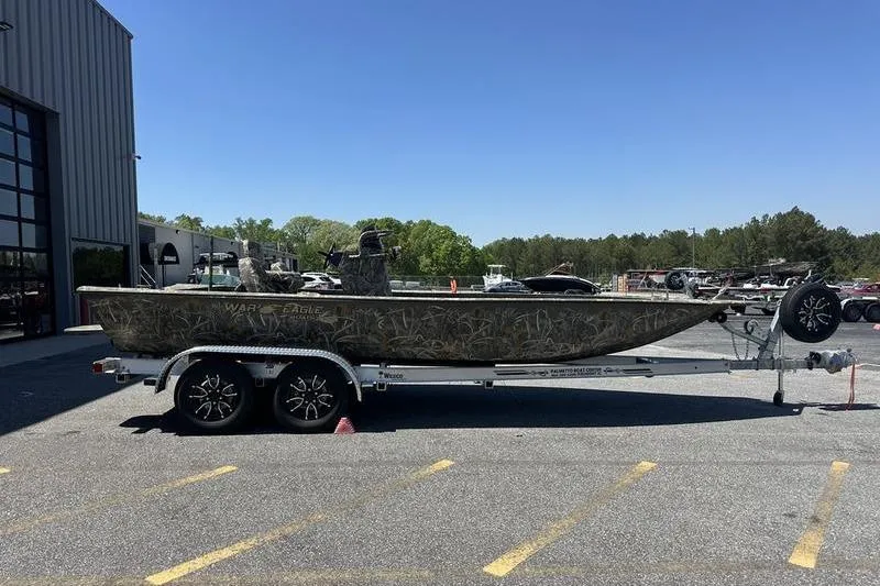 The Image of 2026 War Eagle 2170 Blackhawk boat on trailer, parked outdoors under clear sky. - 1
