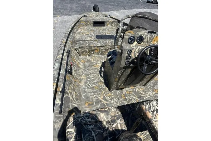 Slide: The Image of 2026 War Eagle 2170 Blackhawk boat interior with camouflage design and control panel. - 3