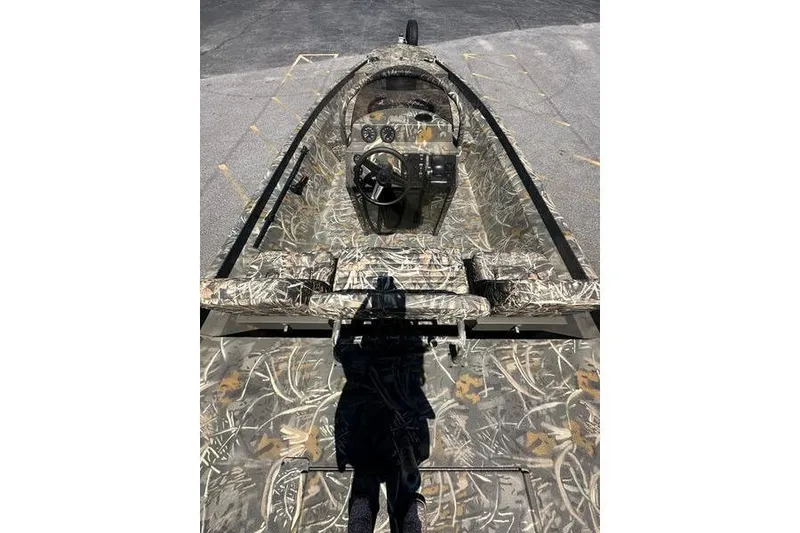 Slide: The Image of 2026 War Eagle 2170 Blackhawk boat with camouflage interior and steering console. - 6