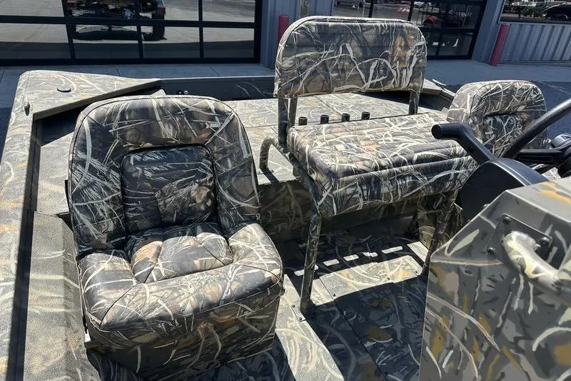 Slide: The Image of 2026 War Eagle 2170 Blackhawk boat interior with camouflage seating and console. - 7