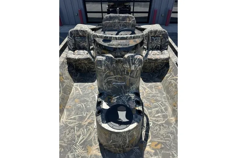 Slide: The Image of 2026 War Eagle 2170 Blackhawk boat interior with camouflage seating and steering console. - 9