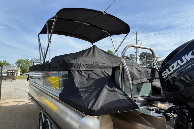 Slide: The Image of 2026 Avalon VENTURE QUAD LOUNGE pontoon boat with Suzuki engine, covered and docked. - 100