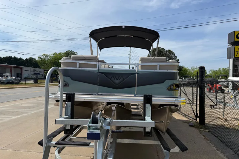 Slide: The Image of 2026 Avalon VENTURE QUAD LOUNGE pontoon boat on trailer, outdoor dealership setting. - 57